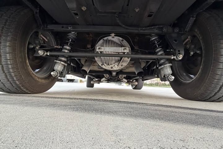 Underneath the rear of the car: four-link bars, coilovers, and the narrowed rear axle